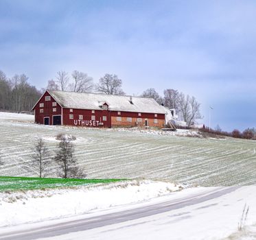 Picturesque red barn on a snowy landscape in Jonkoping County, Sweden. — photo by Damir K .