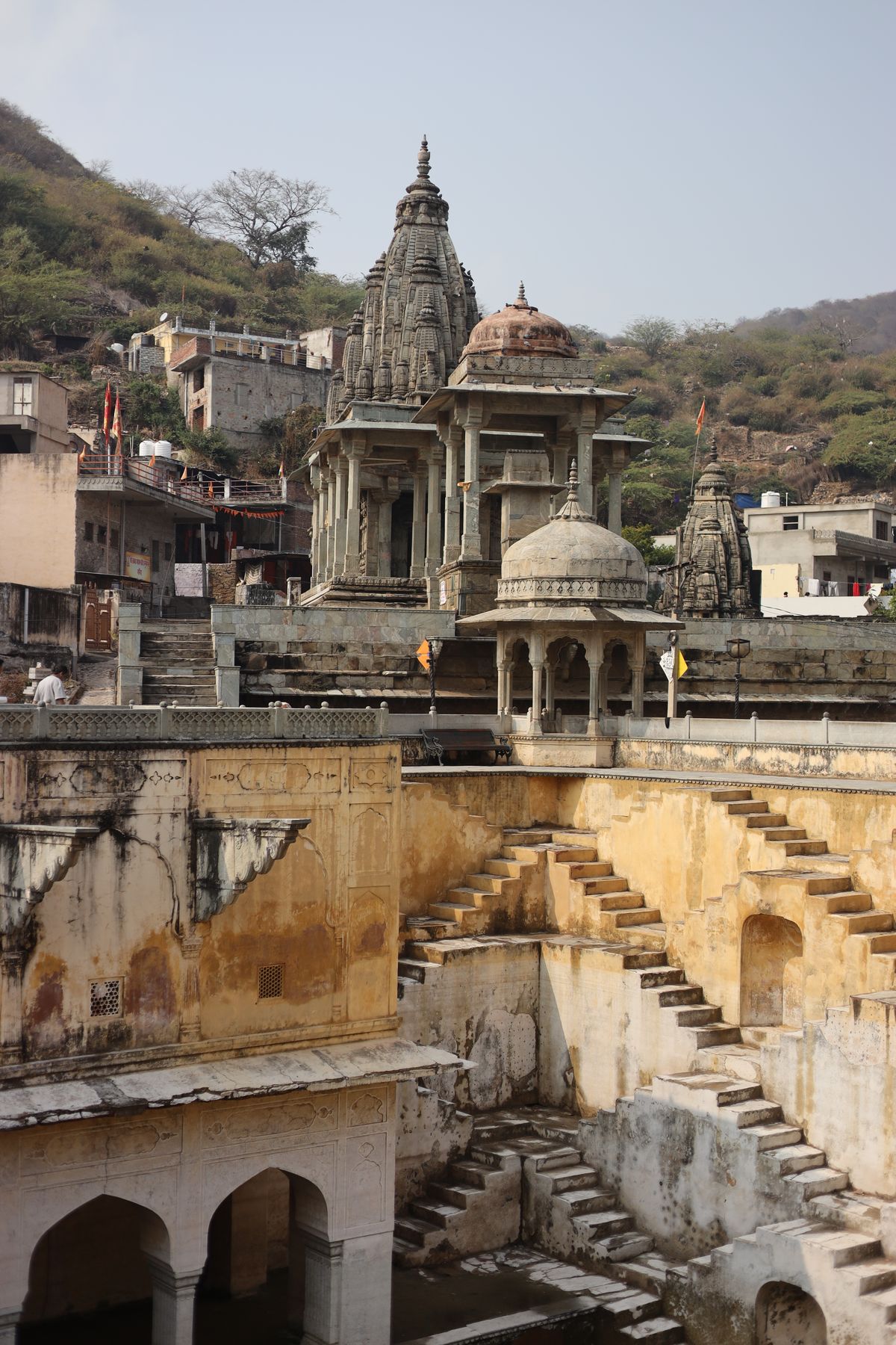 Historic temple architecture with carved stone steps in rural India, reflecting the pilgrimage and stone trades of Karauli district