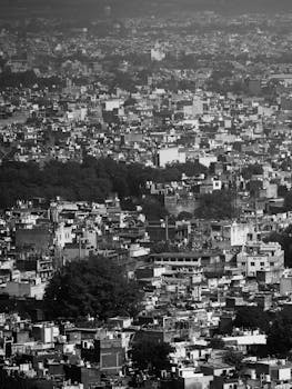 Black and white aerial view of Gwalior city in Madhya Pradesh, India, showcasing urban density.
