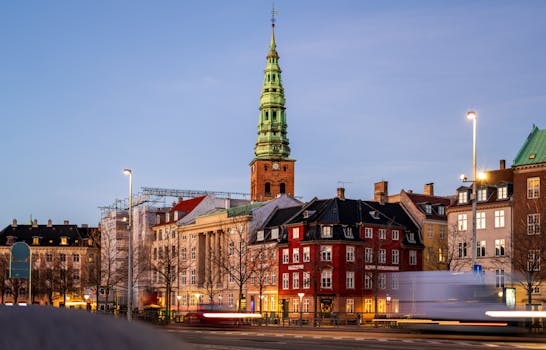 Historic Nikolaj Kunsthal and cityscape in Copenhagen, Denmark, captured during dusk.