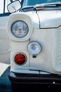 Close-up of a vintage Ford van front headlights in Kinsale, Ireland.