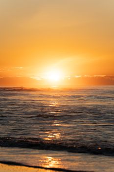 Capture the serene beauty of a radiant sunset over the ocean waves.