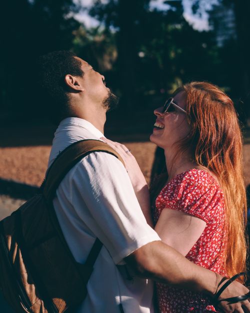 Free A couple joyfully embraces under the sun in Buenos Aires, showcasing love and happiness. Stock Photo