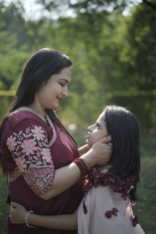 Free A loving mother and daughter sharing a warm moment outdoors in spring. Stock Photo