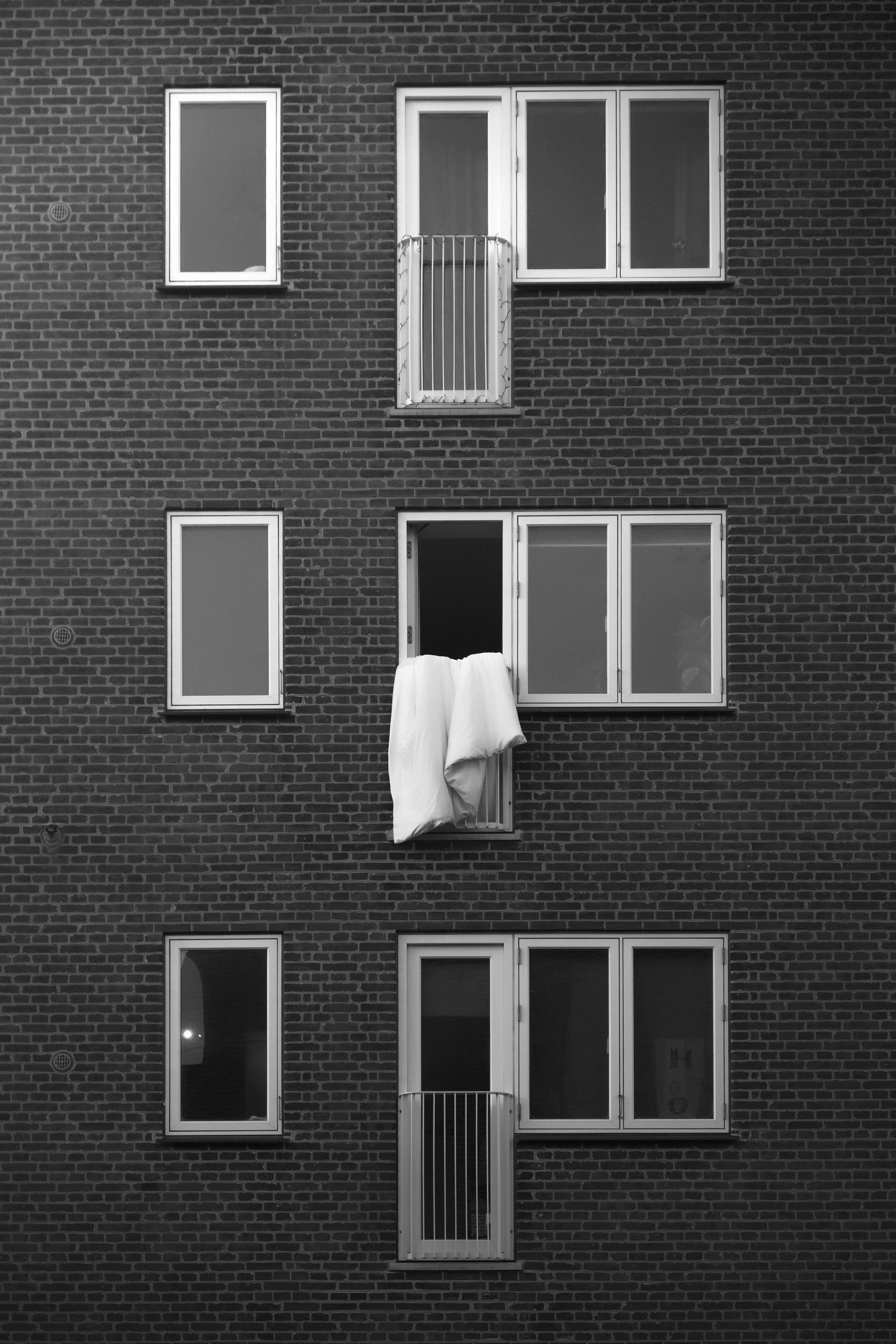 grátis Fotografia em preto e branco da fachada simétrica de um edifício de tijolos em Copenhague. Foto profissional