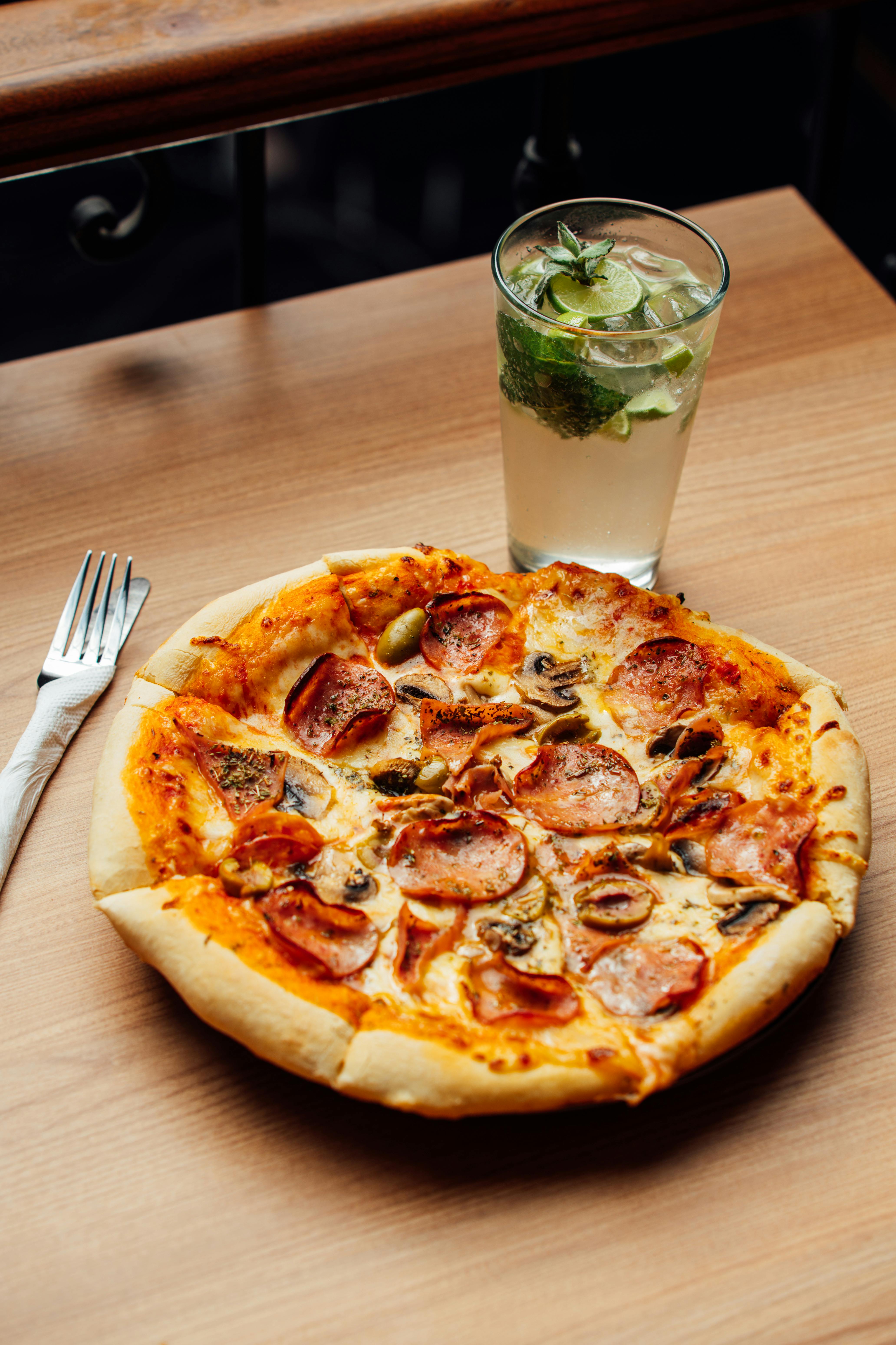 Savor a freshly baked pepperoni pizza paired with a mint lemonade.