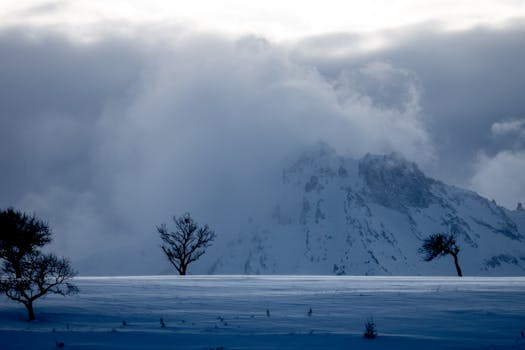 Dramatic winter landscape with snow-covered peaks and misty clouds over Mount Erciyes.