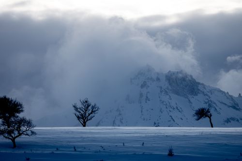 Free Dramatic winter landscape with snow-covered peaks and misty clouds over Mount Erciyes. Stock Photo
