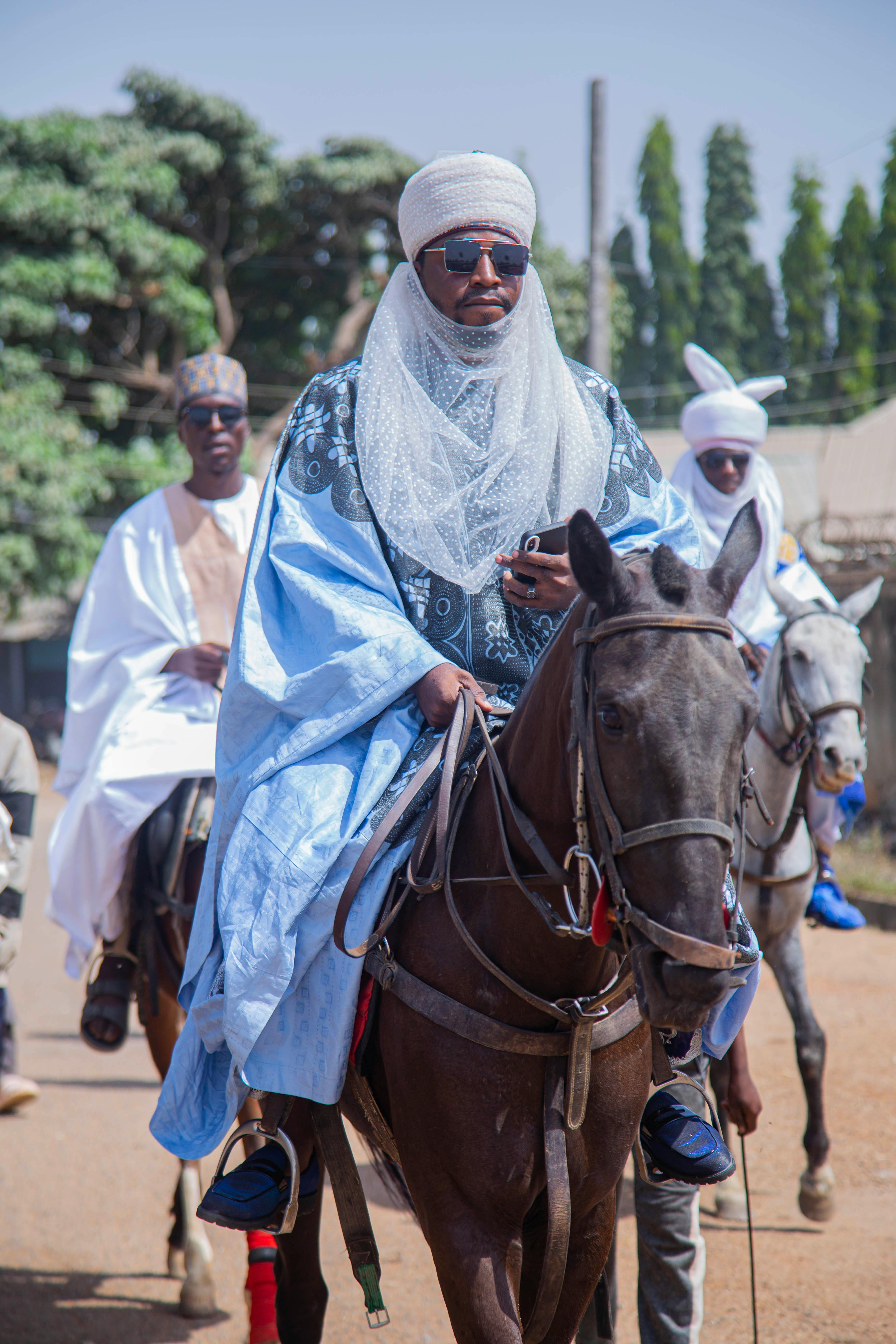 Men in traditional attire on horseback during a cultural event in Kaduna, Nigeria.