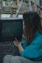 Person Engages with Vintage CRT TV in Library Setting