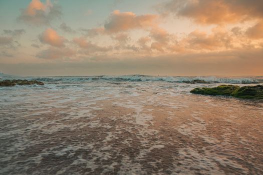 Experience the tranquil beauty of a Quảng Trị sunset with vibrant skies and calming ocean waves.