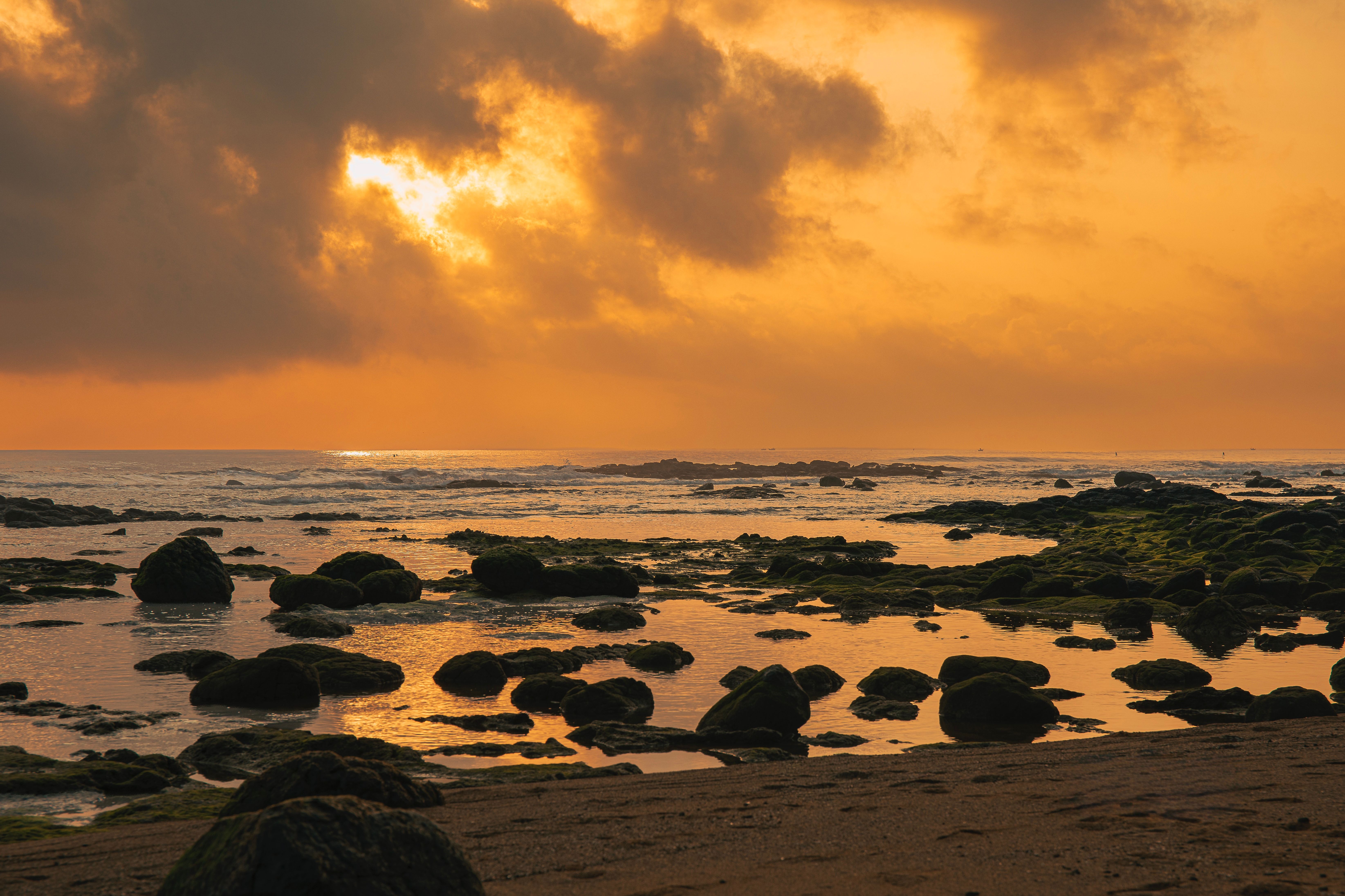 Dramatic Sunset Over Rocky Beach in Quảng Trị · Free Stock Photo
