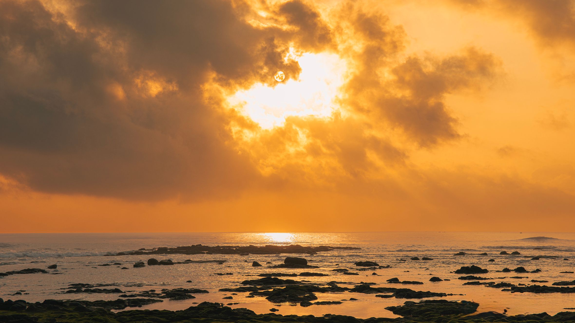 Beautiful orange sunset over a rocky coast in Quảng Trị, Vietnam.