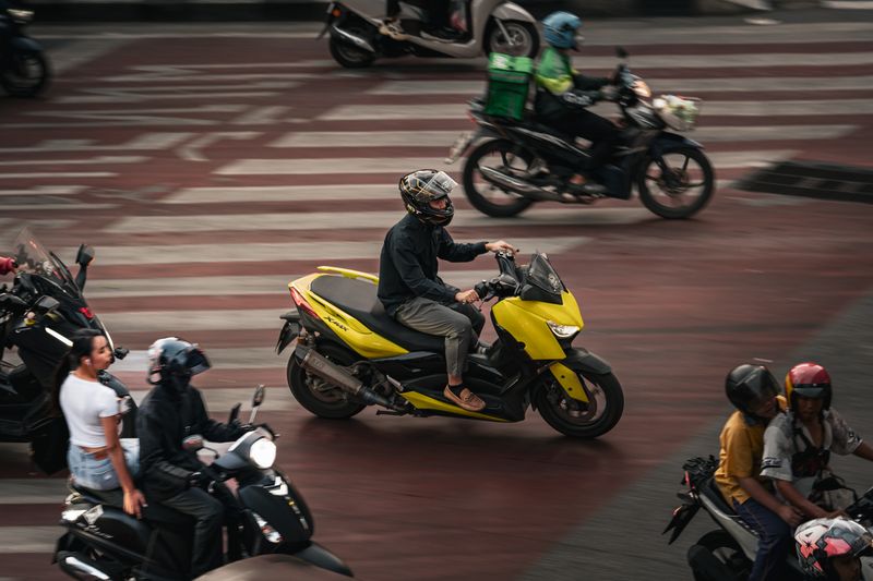 Dynamic urban traffic scene with motorbikes at city intersection.