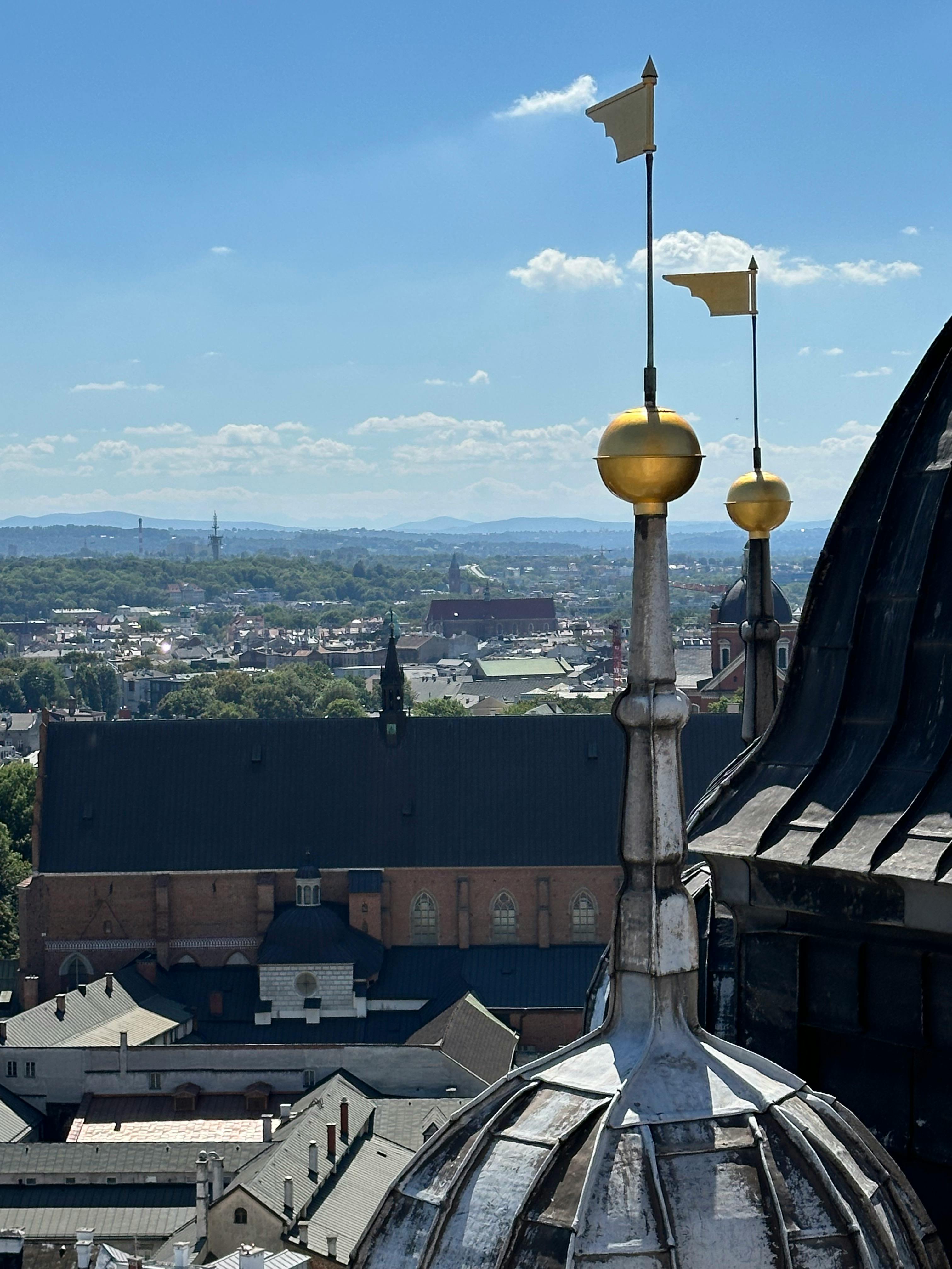 Stunning view of St. Mary's Basilica and Kraków's skyline under a clear blue sky.