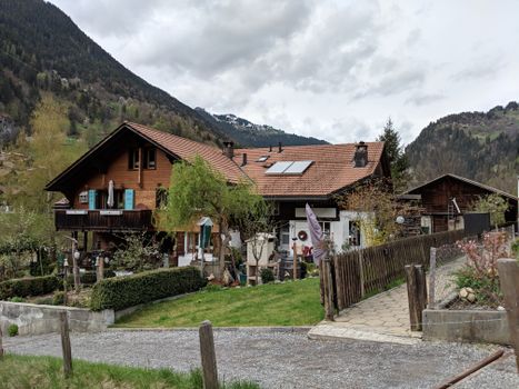 Quaint Swiss chalet nestled in a picturesque mountain landscape, perfect for nature lovers and travelers.