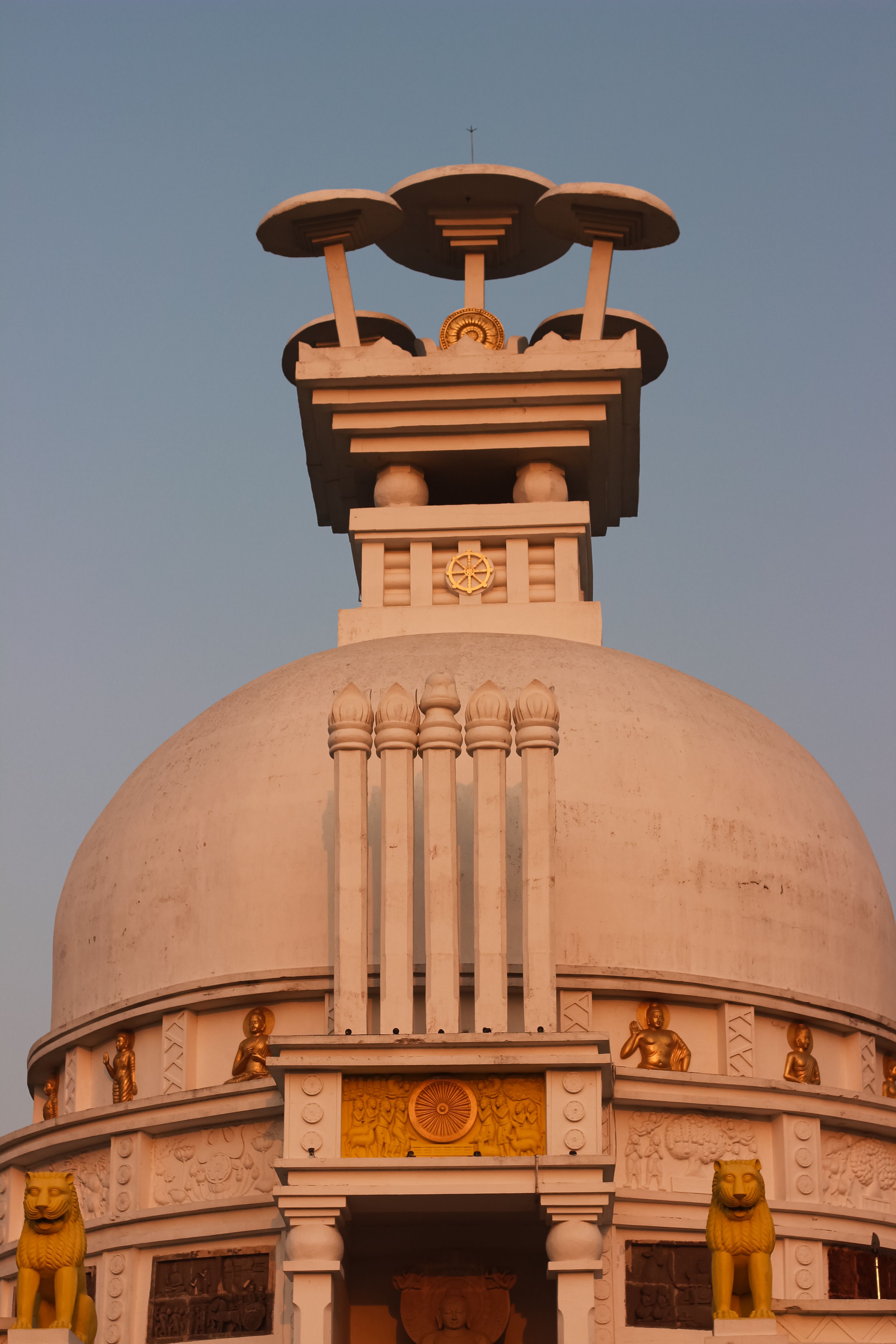 Stunning architecture of Vishwa Shanti Stupa captured at sunset, showcasing intricate Buddhist design.