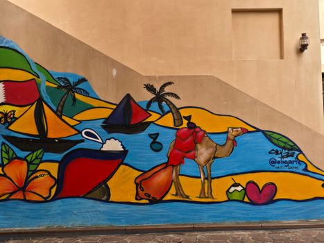Vibrant street art mural depicting a camel, boats, and tropical motifs.