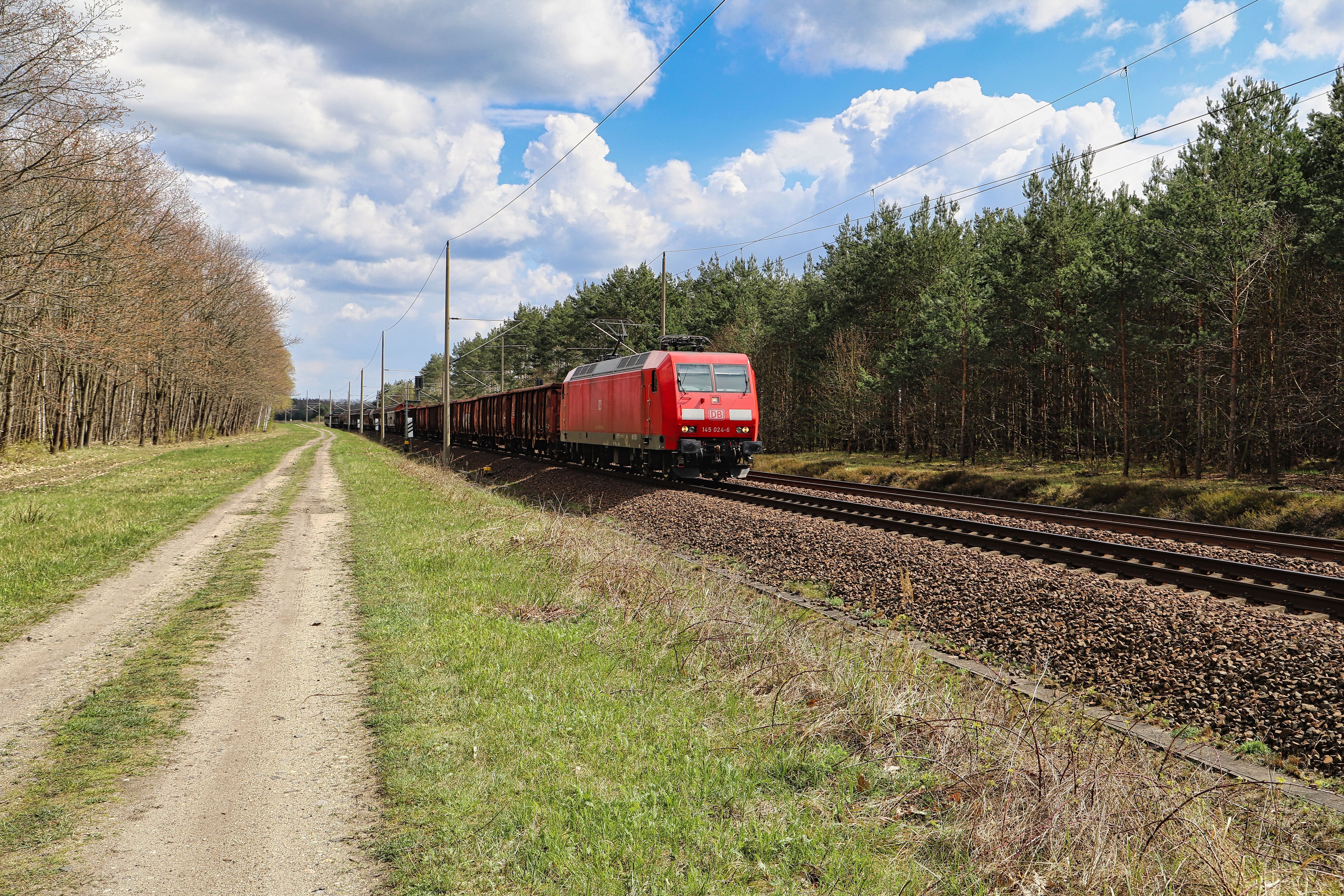 Red Freight Train in Scenic Countryside Setting · Free Stock Photo