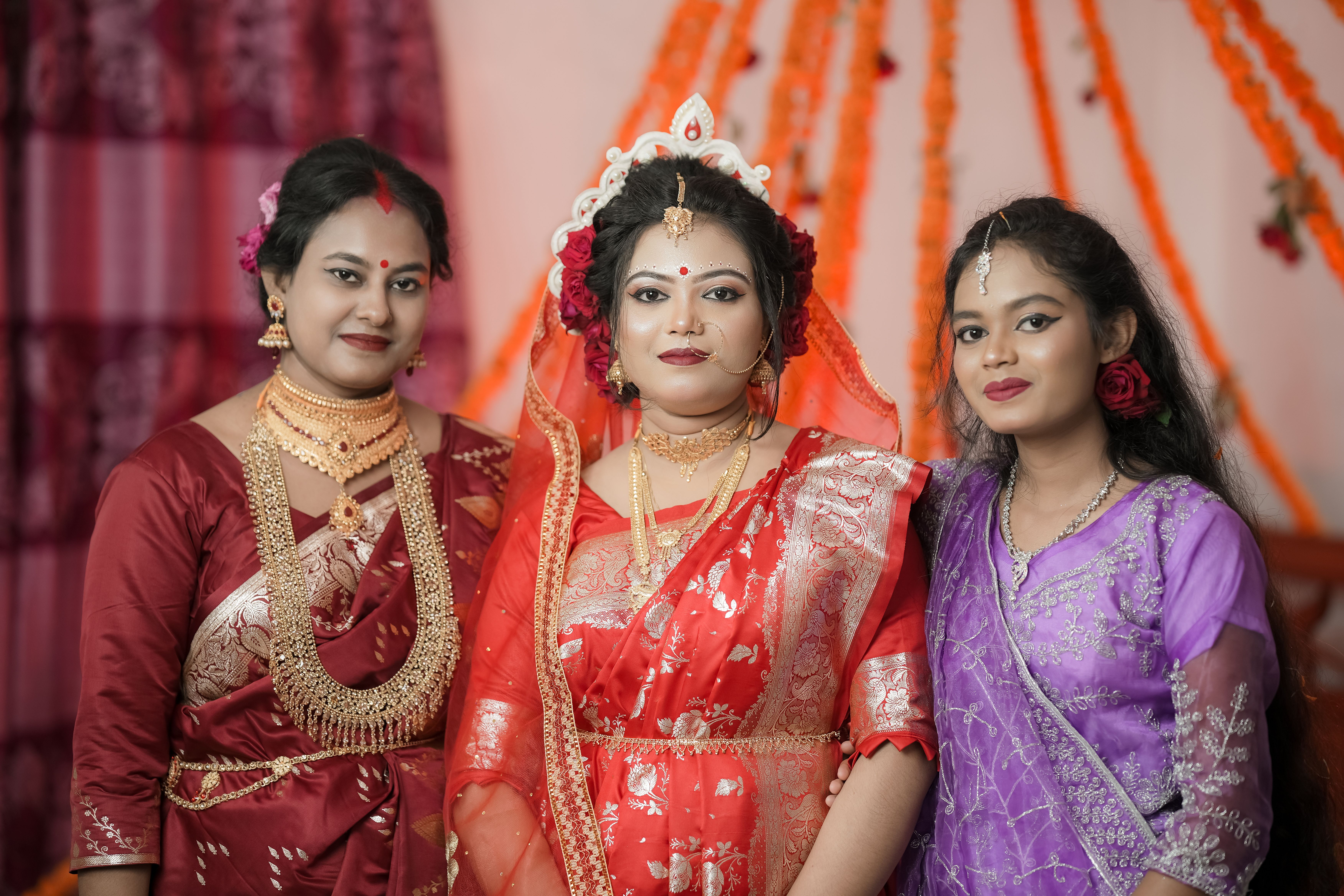 Elegant bridal portrait featuring South Asian women in traditional attire at a wedding celebration.