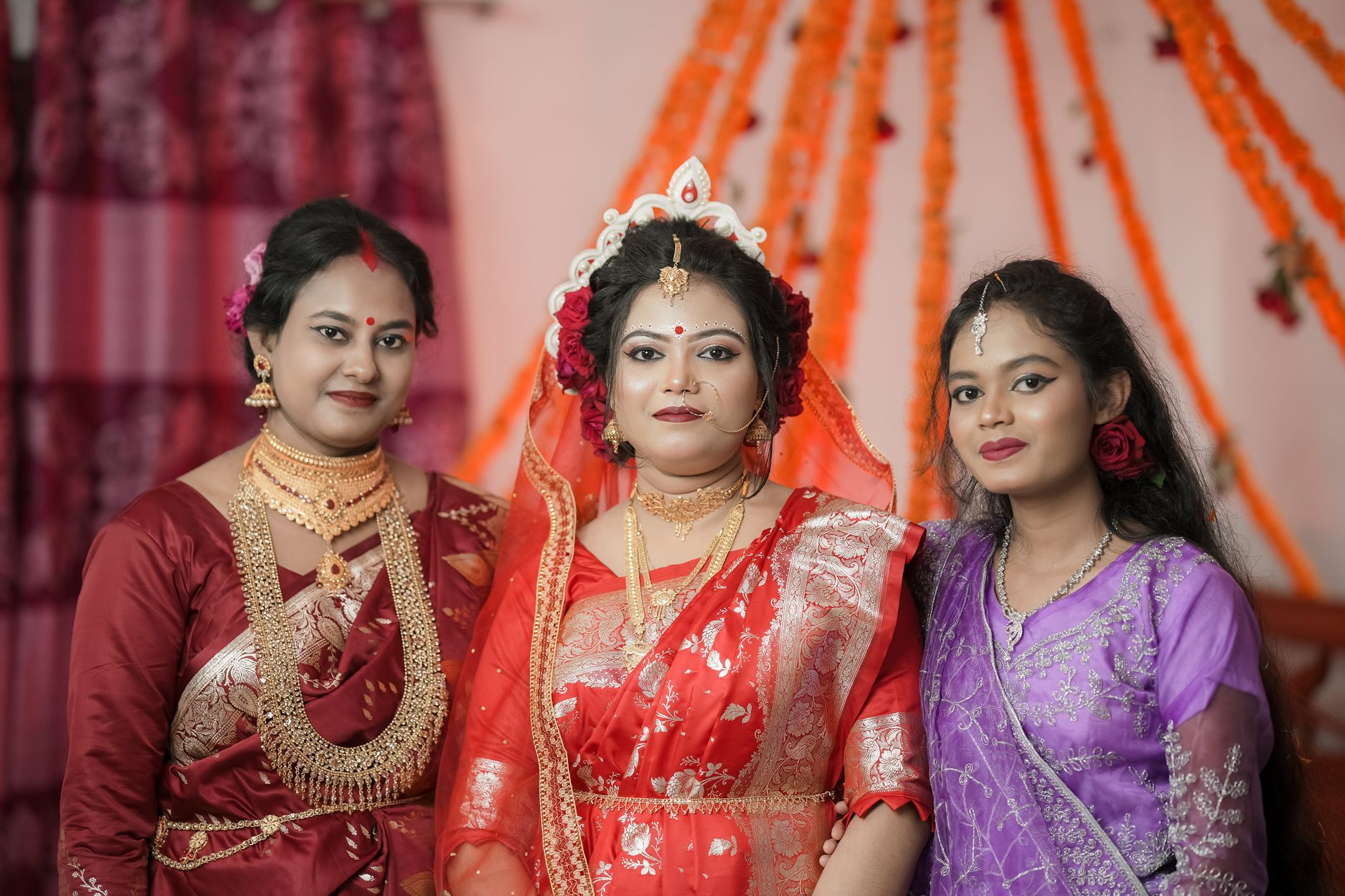 Elegant bridal portrait showcasing South Asian traditional attire and gold jewelry.