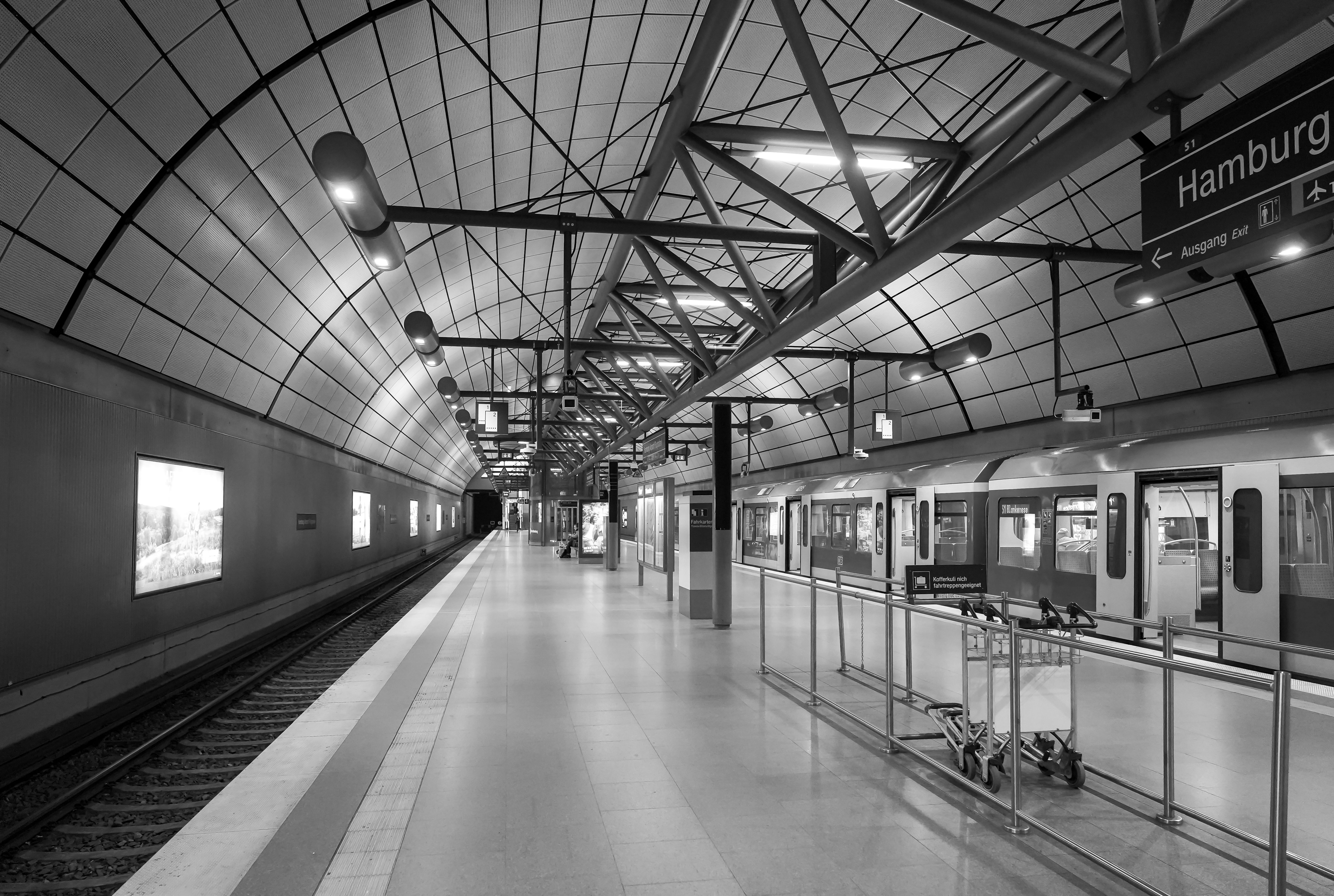 Black and white view of an empty underground train station in Hamburg, Germany.