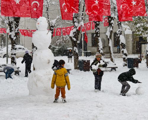 Free Children having fun building a snowman and playing with snow during a festive winter day in Siirt, Türkiye. Stock Photo