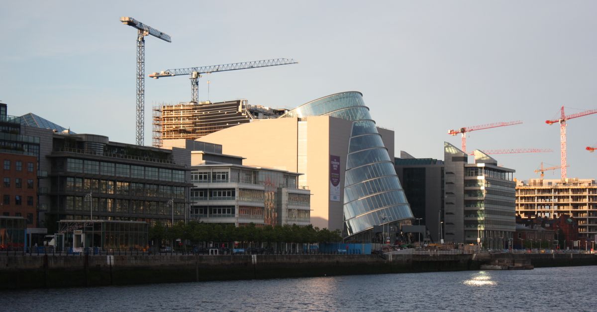 Contemporary architecture and construction cranes along Dublin's iconic waterfront.