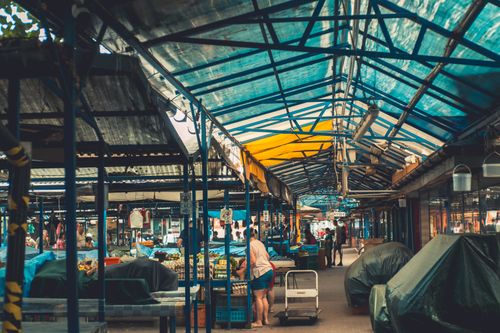 Free Explore the vibrant local market in Krakow, Poland, under colorful canopies. Stock Photo