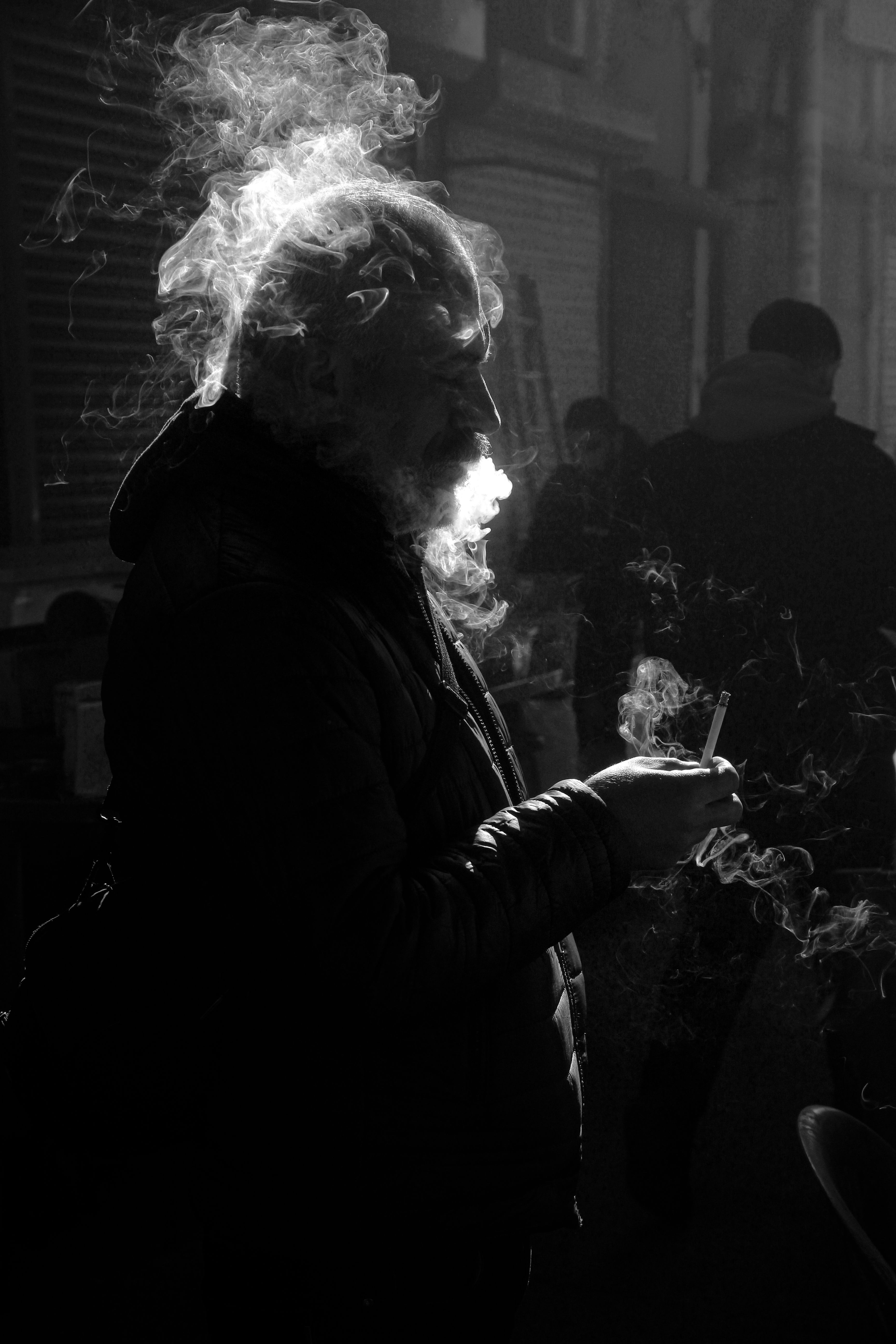 Silhouette of Man Smoking in Urban Shadow · Free Stock Photo