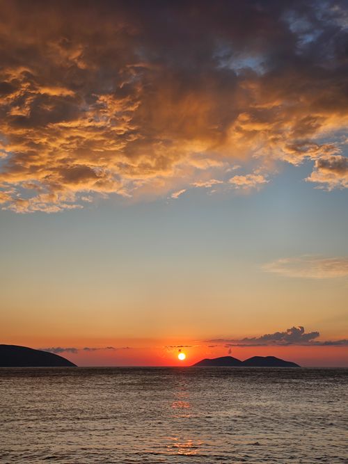 Free Stunning sunset over the Adriatic Sea in Vlorë, Albania, with vibrant clouds and serene waters. Stock Photo