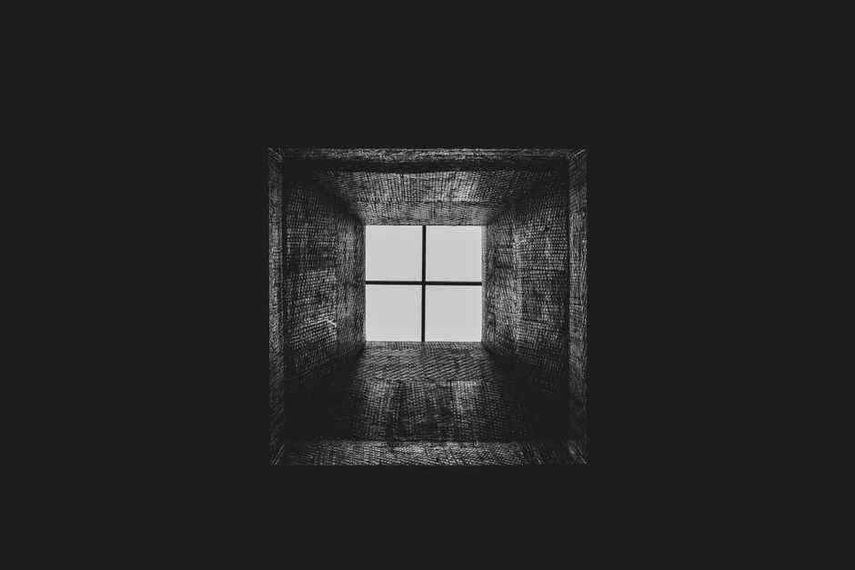 Artistic black and white view of a skylight, showcasing geometric patterns and symmetry.