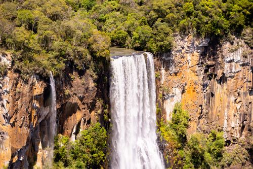 Free Stunning waterfall surrounded by lush greenery in Guarapuava, Paraná, Brasil. Stock Photo