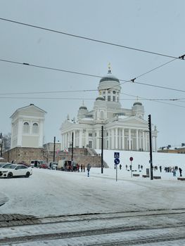 Scenic view of Helsinki Cathedral surrounded by snow during winter.