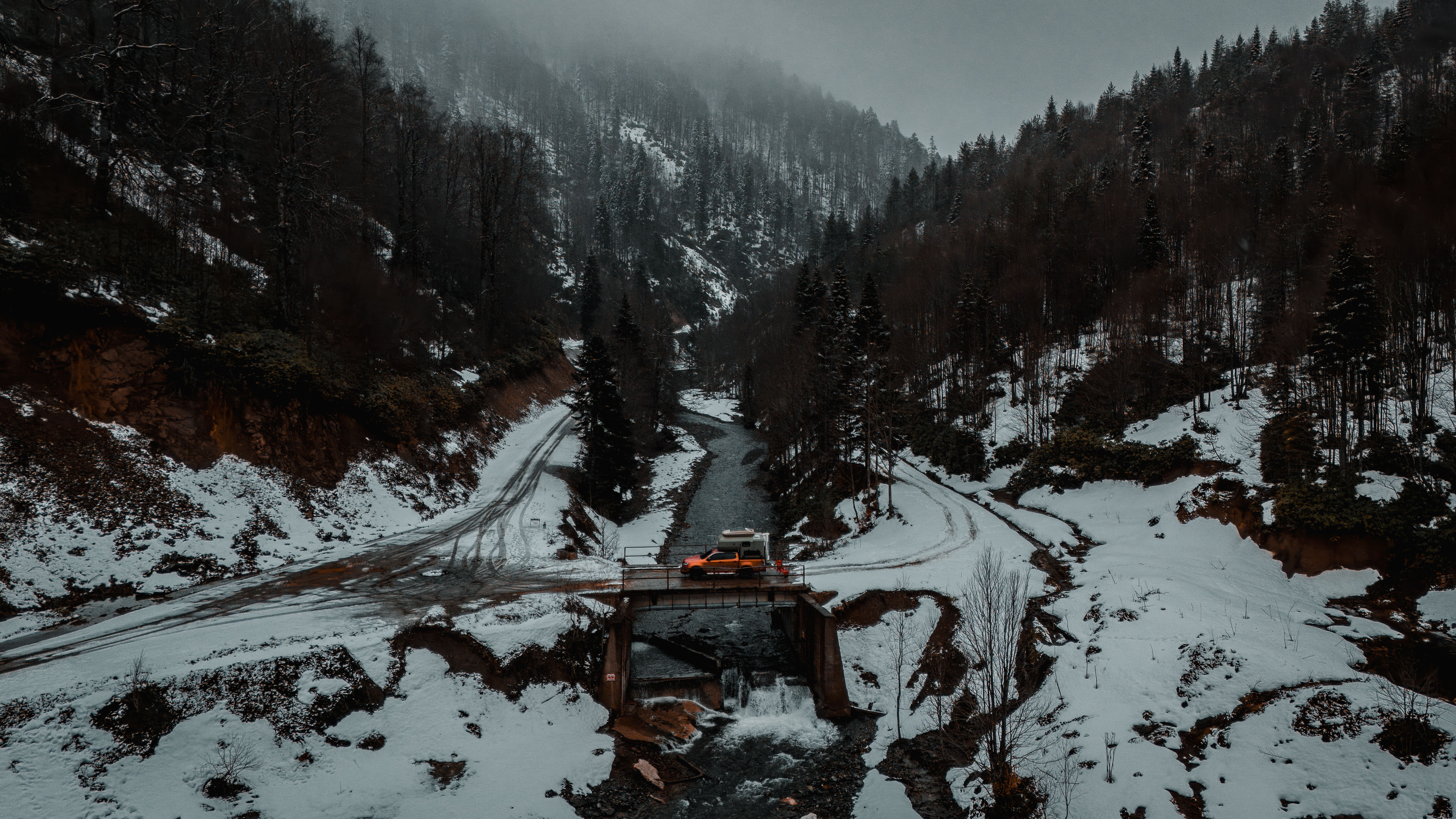 Aerial View of Snowy Mountain Road with Vehicle · Free Stock Photo