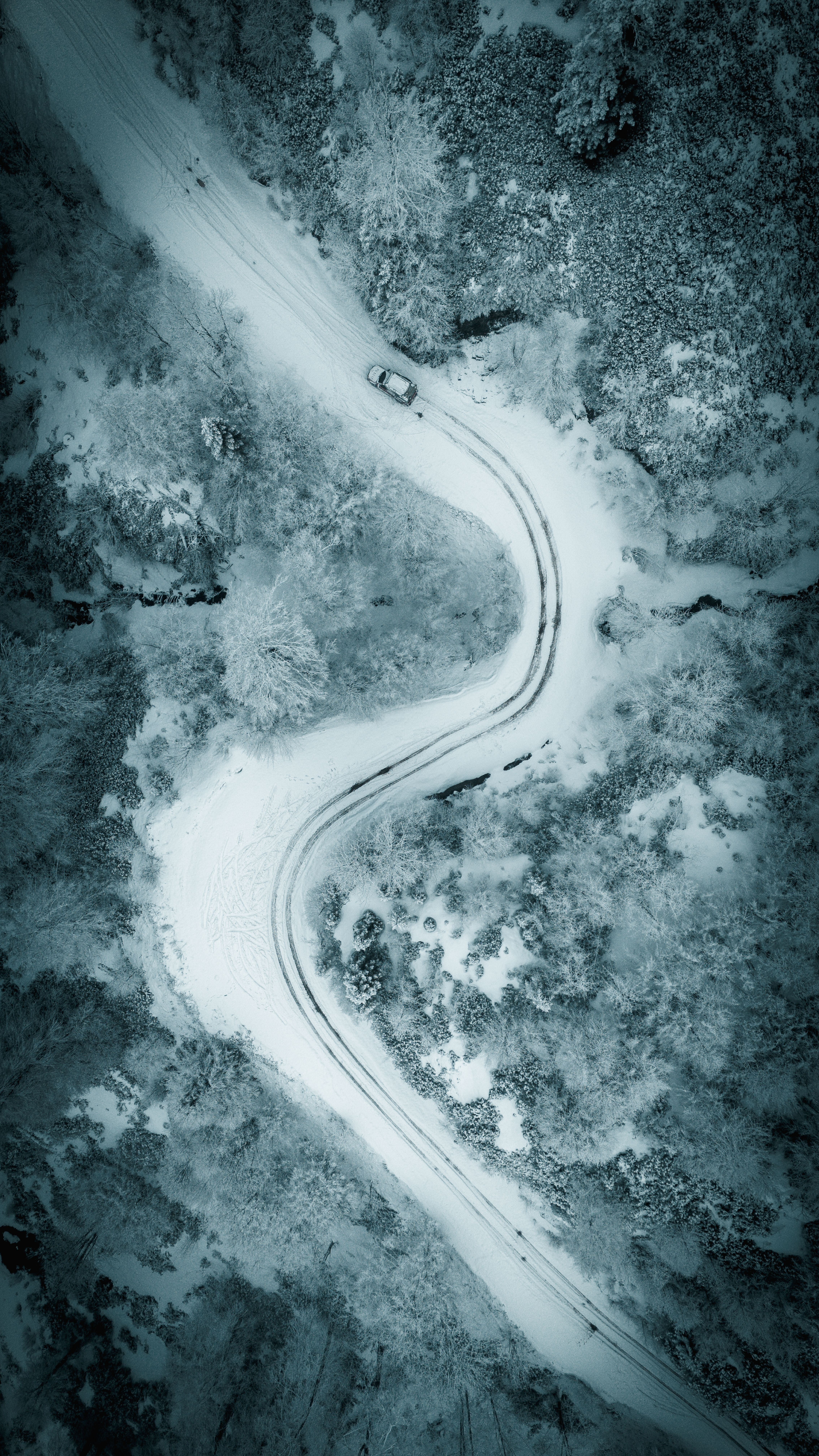 Aerial View of Snowy Mountain Road with Car · Free Stock Photo