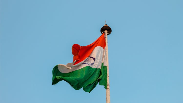 Photo Of A Flag In A Pole Being Blown By Air