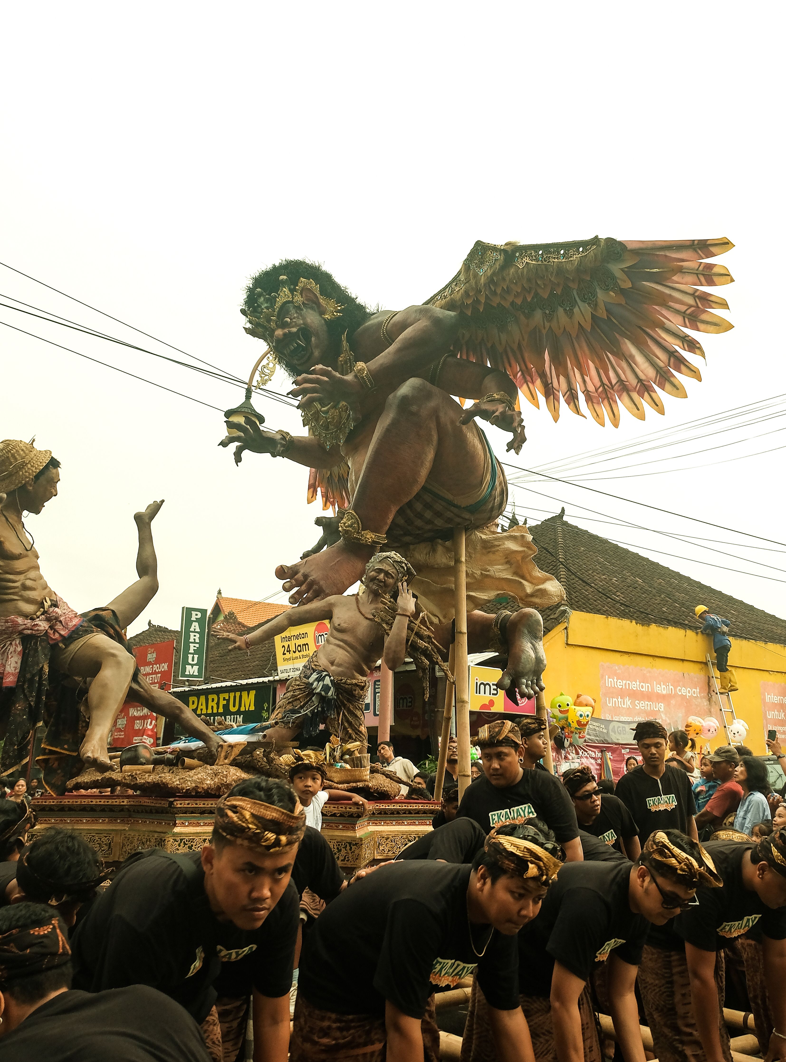 Large papier-mache ogoh-ogoh effigy paraded through a Bali street the night before Nyepi day of silence