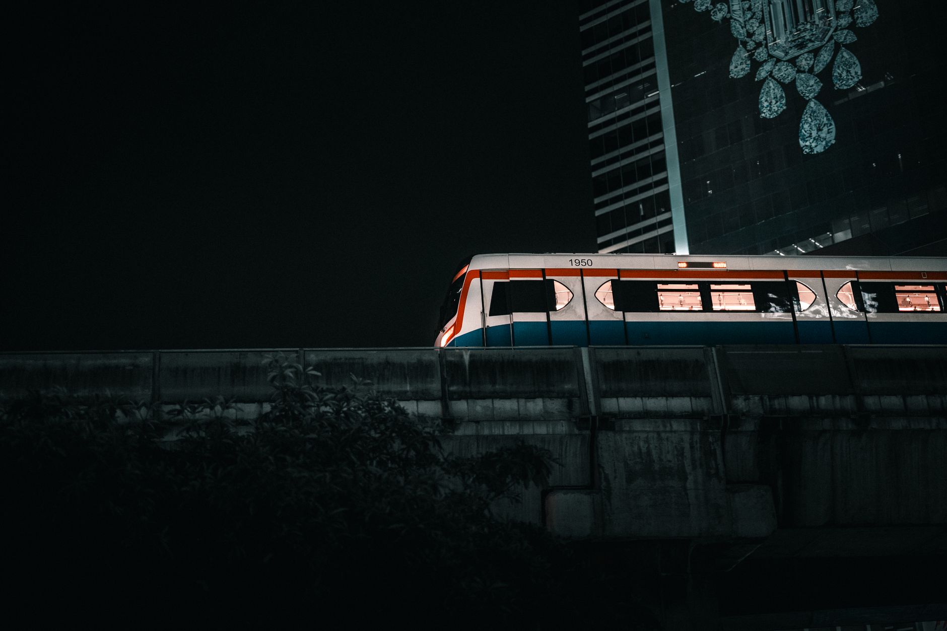 BTS Skytrain platform above a busy Bangkok street at dusk