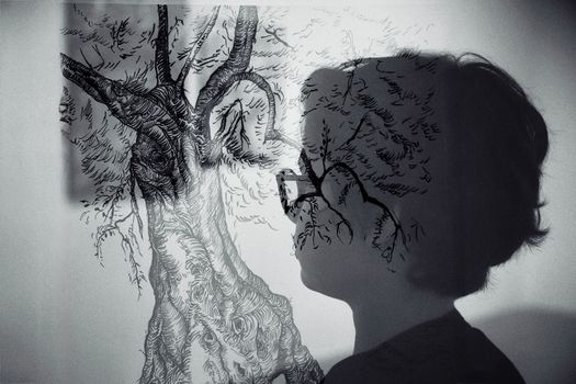 Artistic double exposure of a person and tree sketch creatively blending nature and humanity.