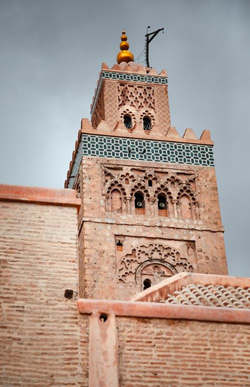 Free Iconic Koutoubia Mosque minaret against a cloudy sky in Marrakech, Morocco. Stock Photo