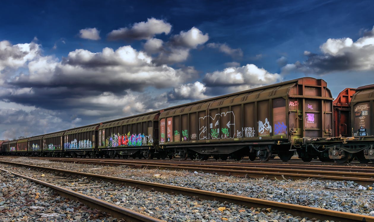 Brown Train Under Cloudy Sky