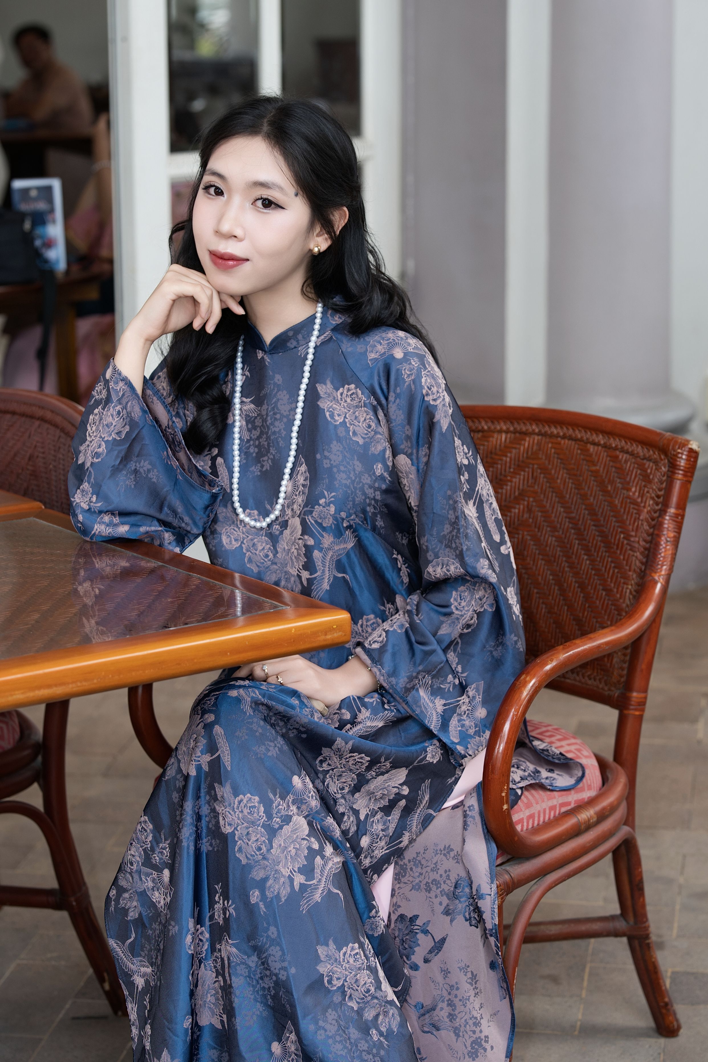 Elegant Woman in Traditional Dress Seated Indoors · Free Stock Photo