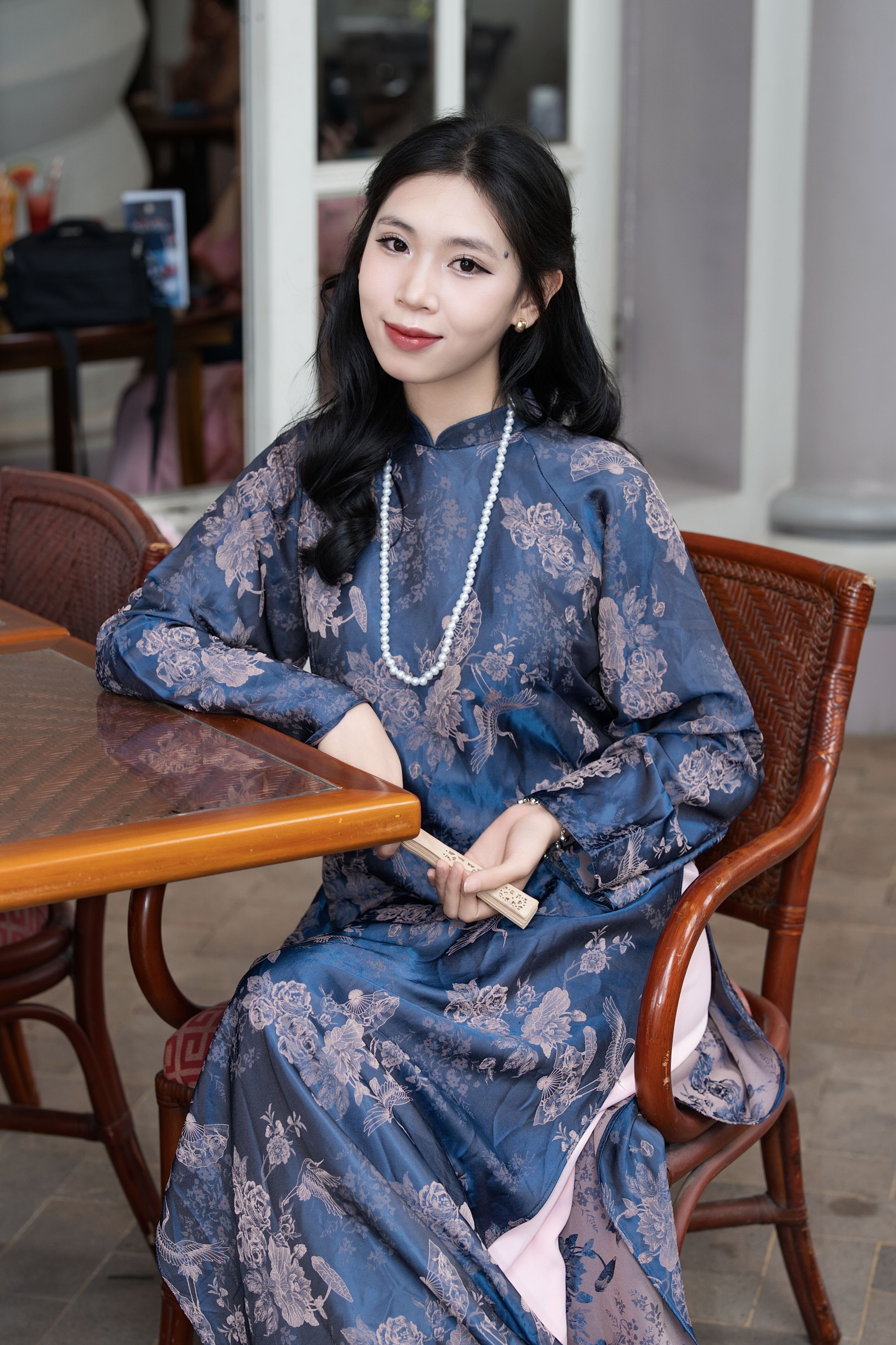 Elegant Woman in Blue Floral Dress Indoors · Free Stock Photo