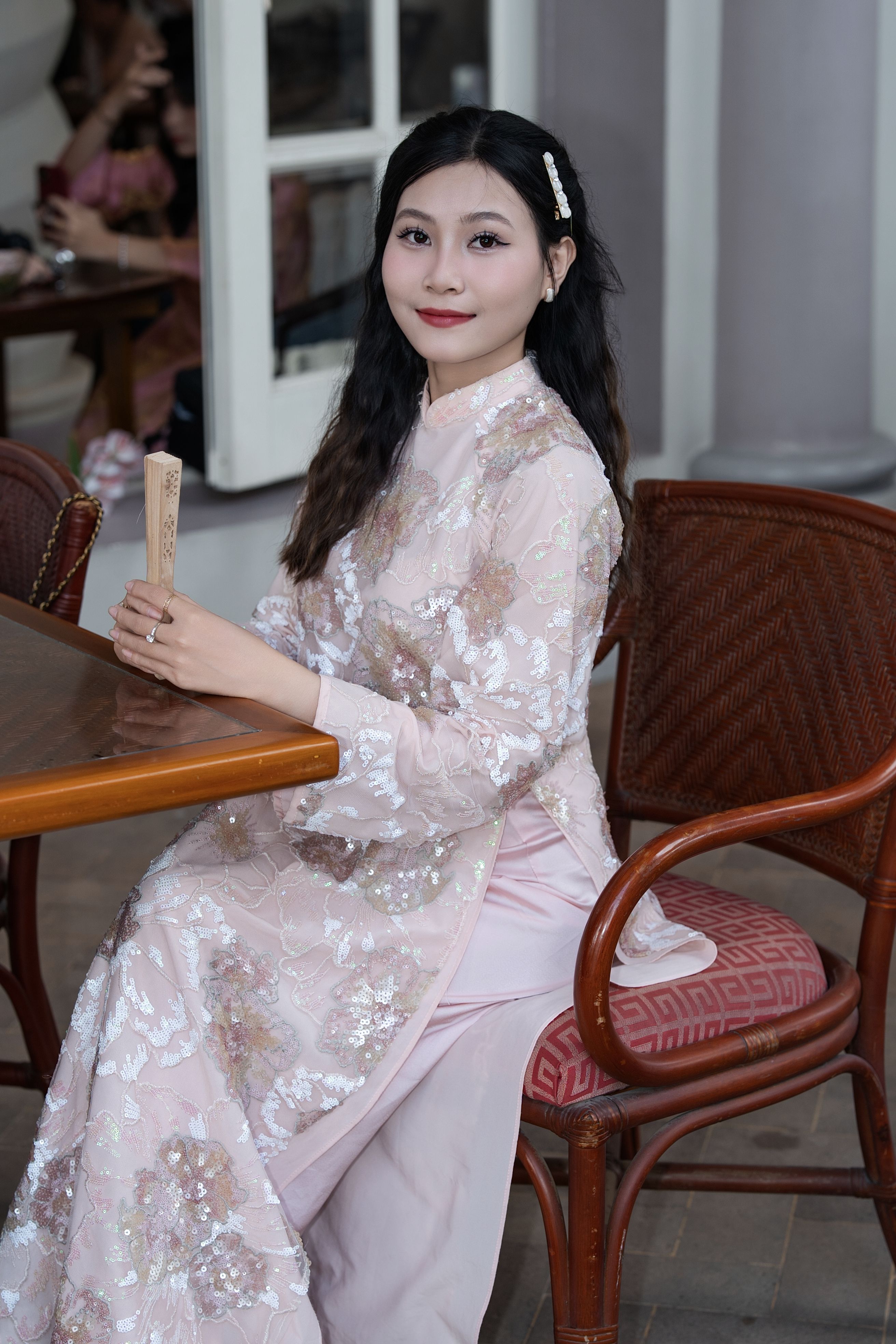 Elegant Woman in Traditional Dress Seated Indoors · Free Stock Photo