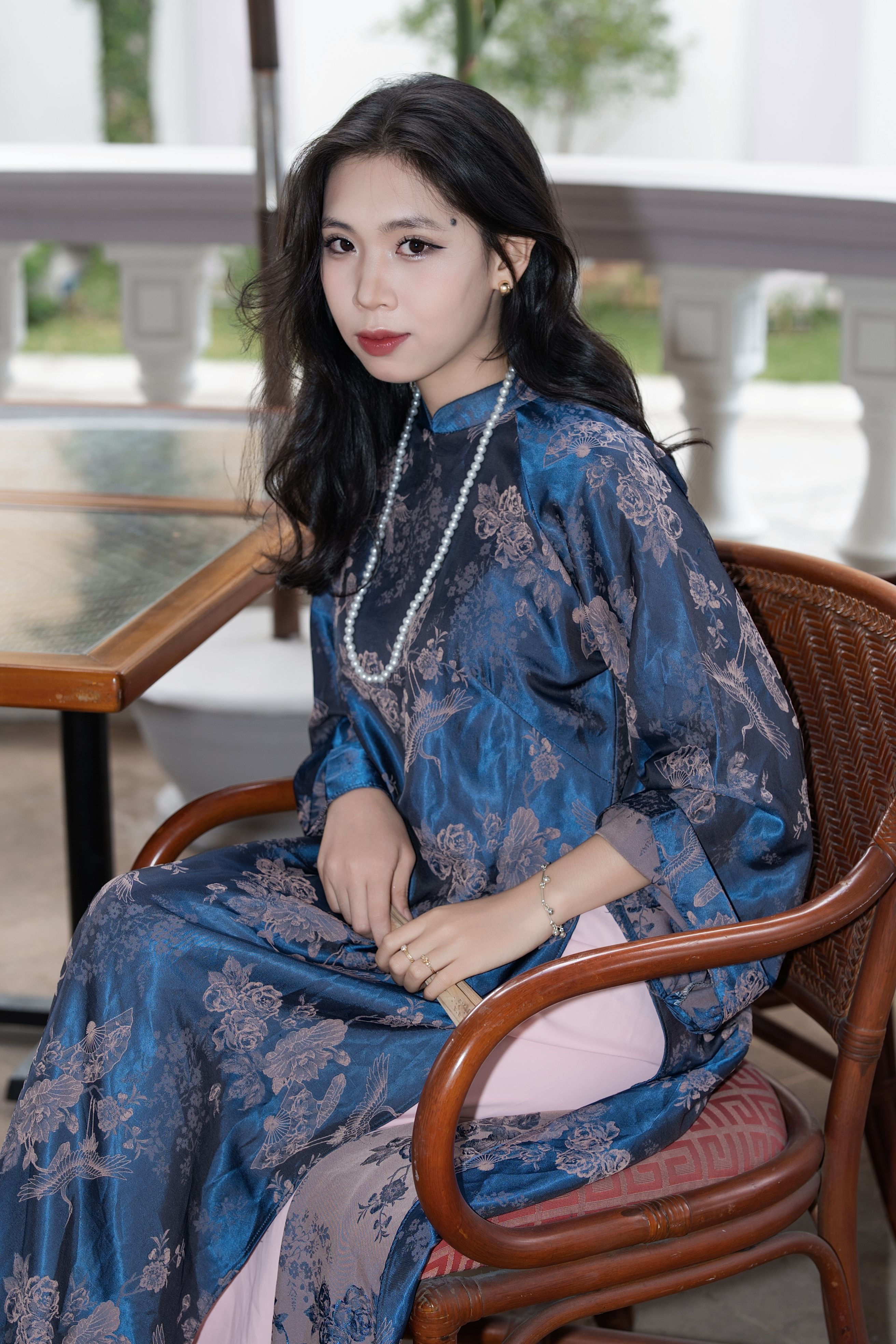 Elegant Woman in Traditional Dress Seated Indoors · Free Stock Photo
