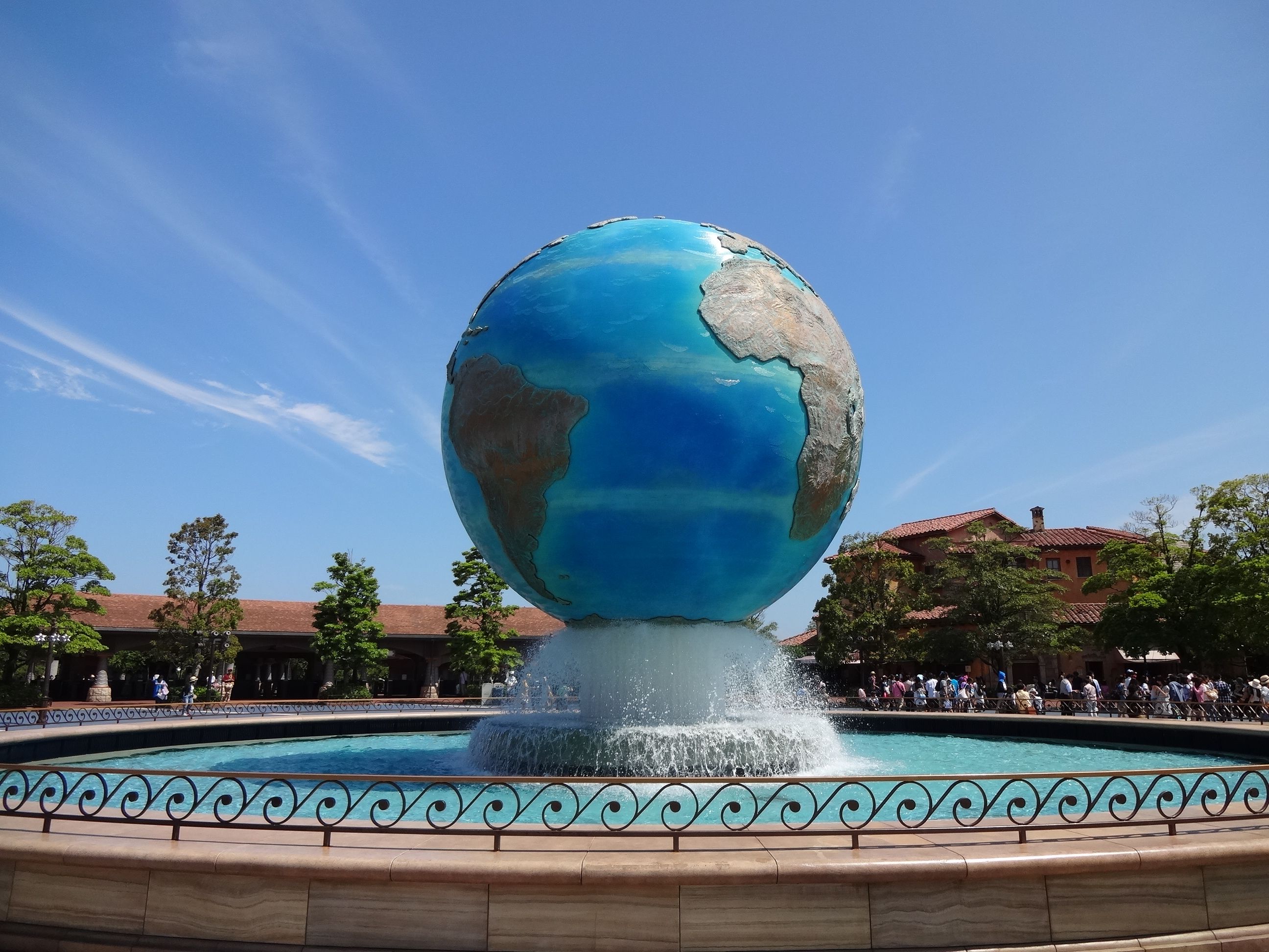 Stunning view of Earth sculpture fountain at Tokyo DisneySea under a clear blue sky.