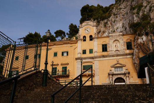 View of the historic Sanctuary of Santa Rosalia in Sicily set against a rocky backdrop.