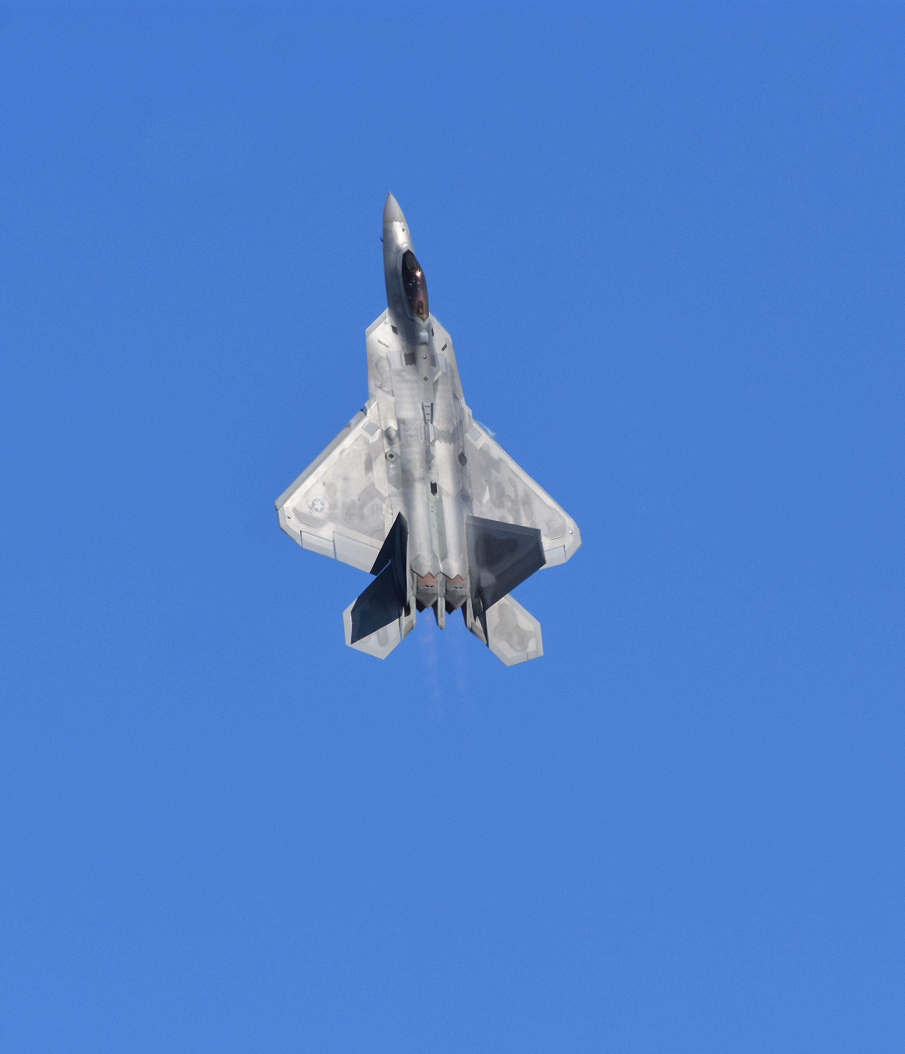 Military Jet Flying Vertically Against Blue Sky · Free Stock Photo