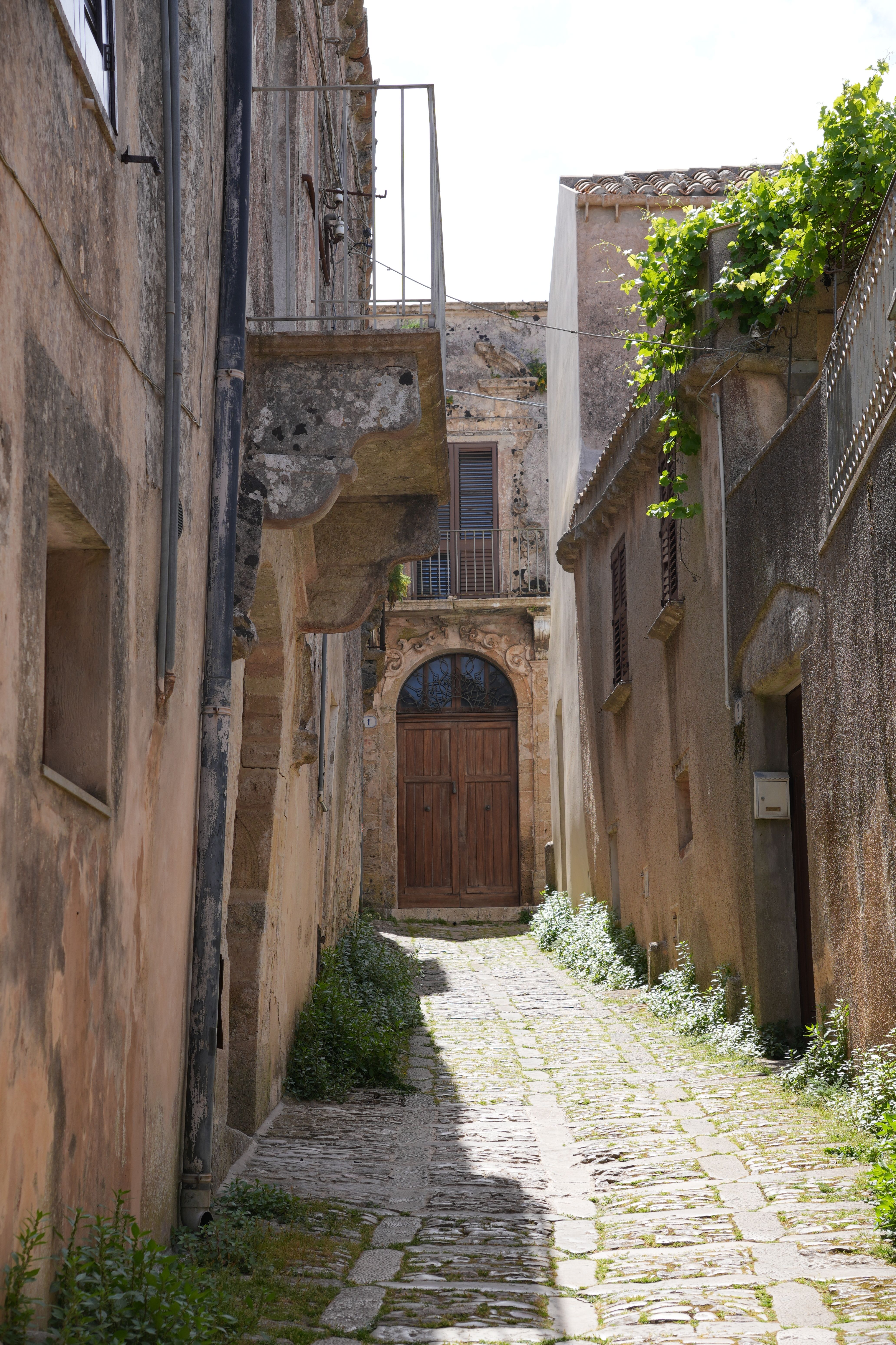 Explore the rustic charm of a narrow stone alleyway in Erice, Sicily, Italy.
